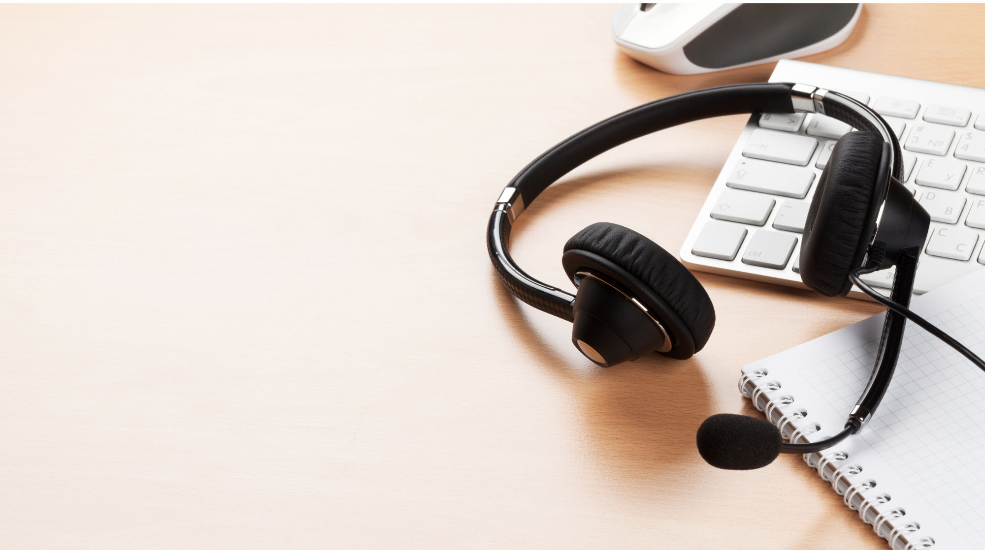 keyboard and headset indicating helpline services available by phone